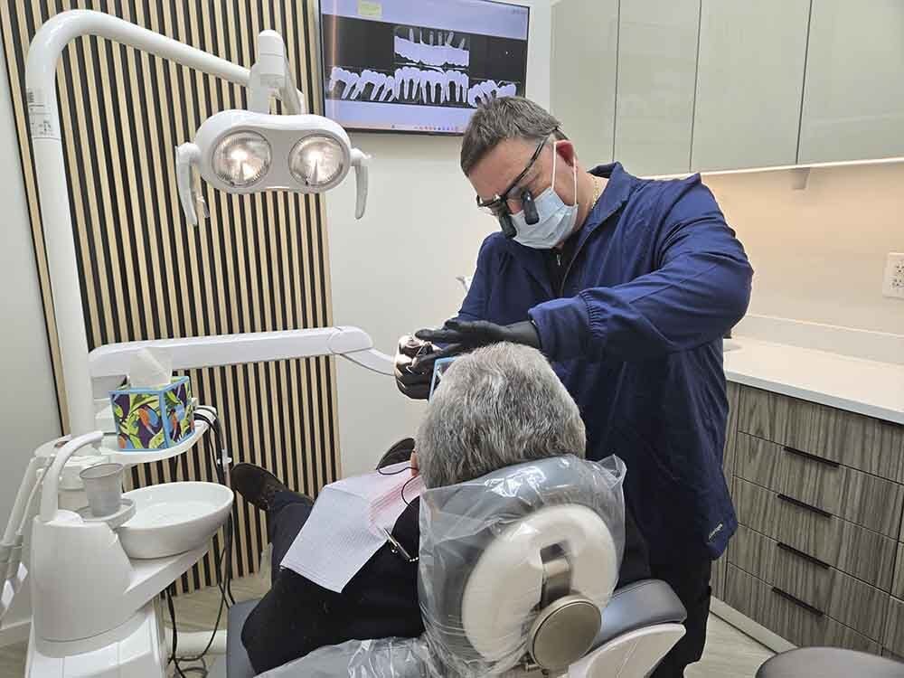 Dr. Igor Levin providing dental treatment at VITAdent on Ave X in Sheepshead Bay, Brooklyn, NY
