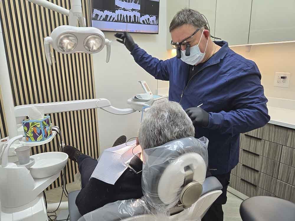 Dentist providing care to a patient at VITAdent Brooklyn