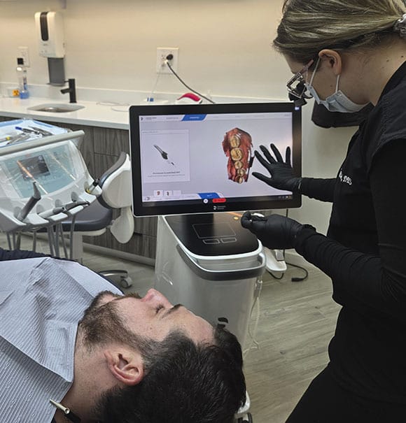 Dentist explaining personalized dental care to a patient at VITAdent Brooklyn