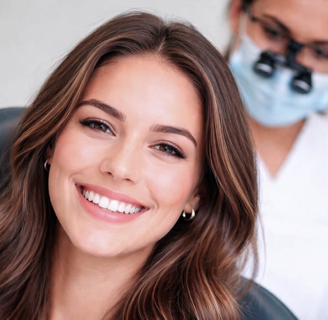 Patient with an aesthetically pleasing smile after cosmetic dental treatment at VitaDent Brooklyn on Avenue X in Sheepshead Bay, Brooklyn 11235.