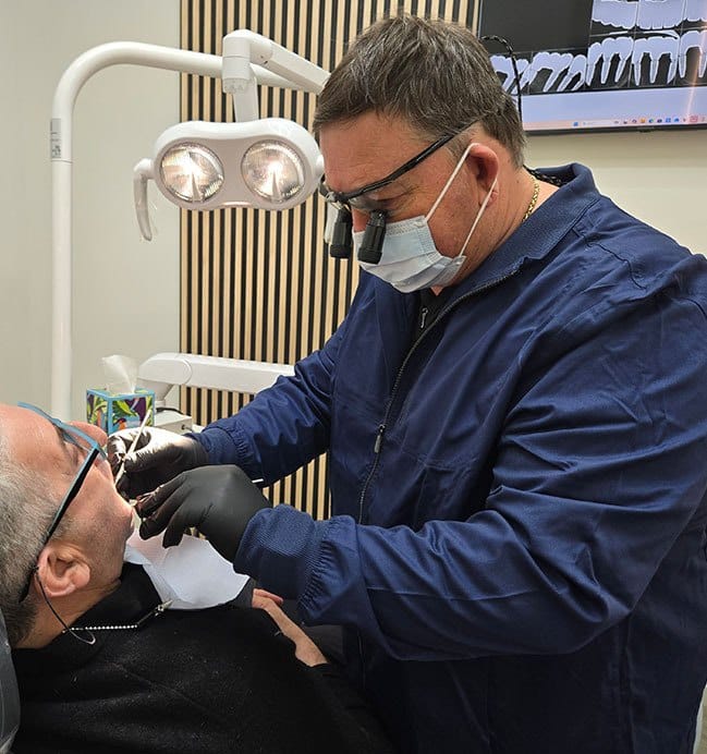 Dentist reviewing dental implant candidacy during a consultation in Sheepshead Bay, Brooklyn