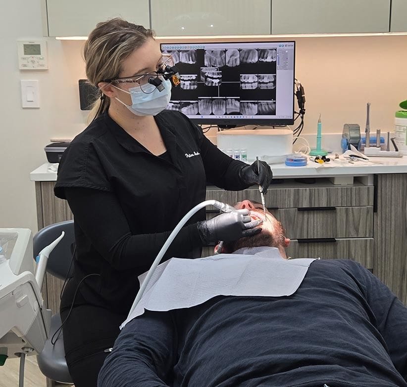 Dental hygienist performing professional teeth cleaning during preventative dental visit in Sheepshead Bay, Brooklyn