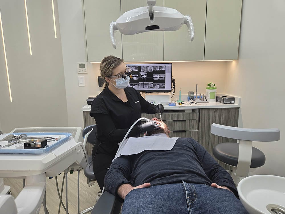 Dentist performing dental filling treatment at VitaDent Brooklyn.